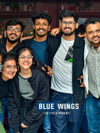 A group of guys and girls smiling for the camera. A great night out with the whole crew.