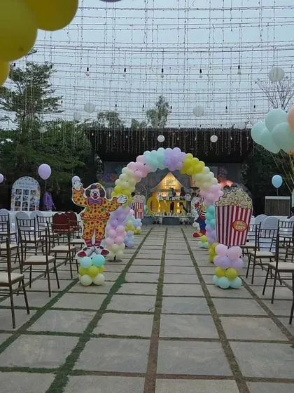 The grand walkway for Vihaan's carnival party. We lined the path with clown cutouts and a pastel balloon arch, leading guests towards the main event under a canopy of lights.