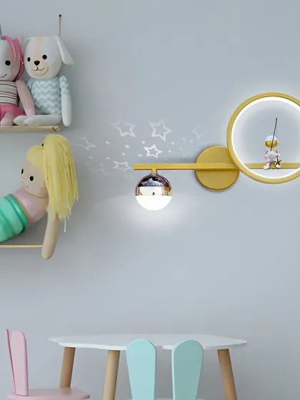 The astronaut fishing wall light shown in a kid's room setting. It's a playful and imaginative piece that sparks joy.