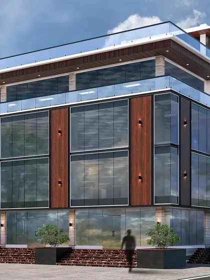 A 3D render for a proposed commercial building on Sarjapur Road, featuring a wide glass facade and a prominent terrace space on the upper floor.