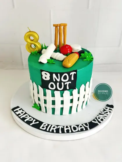 "8 Not Out!" A creative cricket-themed cake for an 8th birthday, complete with a wicket, bat, and ball.
