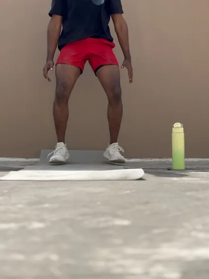 A close-up of the drop squat from my vacation workout routine.