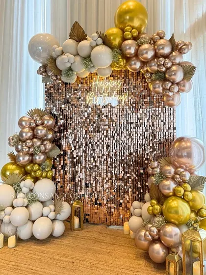 A closer look at this gorgeous rose gold, gold, and white birthday backdrop. The combination of the shimmer wall and the layered balloon garland creates incredible depth and texture.