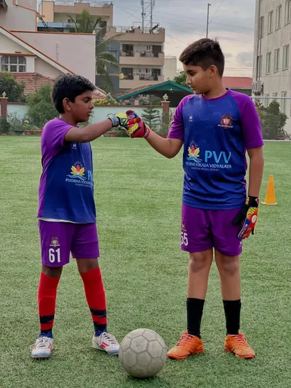 A fist bump of respect and teamwork between our young goalkeepers. We foster a supportive environment where players push each other to be better.