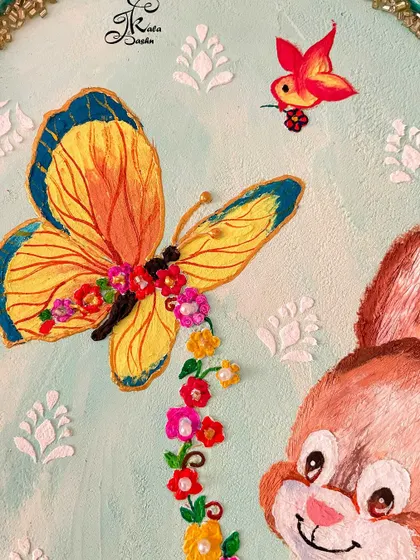 A close-up of the butterfly and bird details on the bunny wall art.