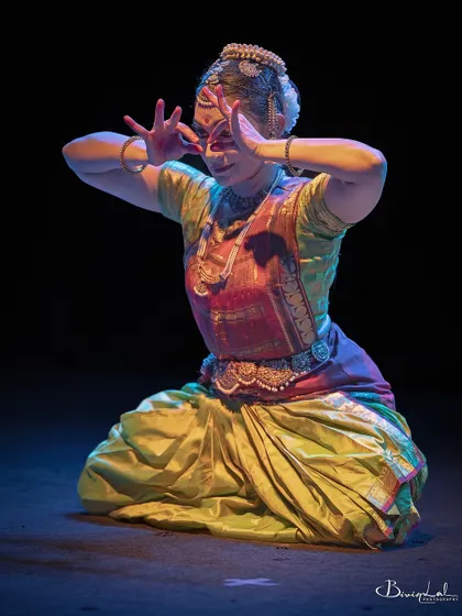 A pose that combines strength and grace, captured during a live performance.