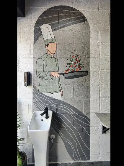 Another view of the chef mural, showing its placement next to the wash basin.
