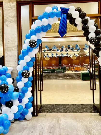 A Boss Baby themed entrance arch with a creative balloon tie, welcoming guests to the party.