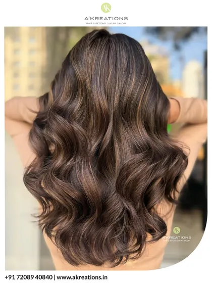 This is the glow-up you've been dreaming of. We created these dazzling warm brown highlights, styled into soft, luxurious waves that catch the light perfectly. This look brings incredible life and dimension to brunette hair.