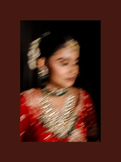 An artistic motion-blur photo of the bride, creating a dreamy and ethereal feel that focuses on the colors and sparkle of her attire.