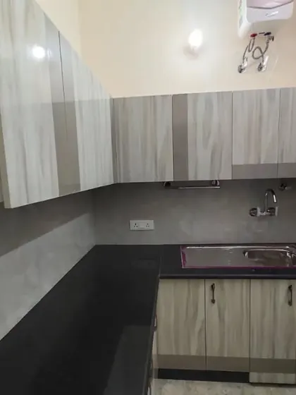 A different view of the rental kitchen, showing the L-shaped layout that maximizes counter space and storage in a compact area.