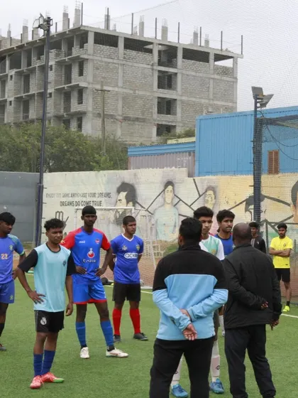 A group of trialists listens intently to a coach's instructions. Discipline and the ability to learn are key attributes we look for in our players.