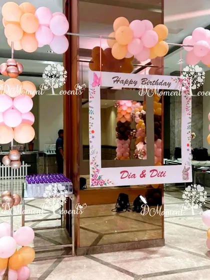 A fun, interactive photo frame for a twins' birthday party, allowing guests to take personalized pictures.