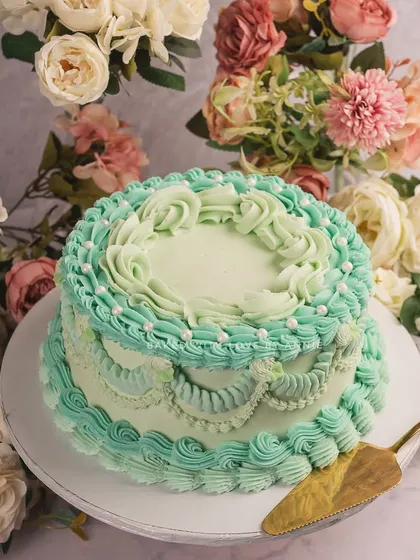 Vintage Victorian charm at its best. My dark chocolate ganache layer cake is frosted in shades of Tiffany blue with crisp Lambeth detailing.