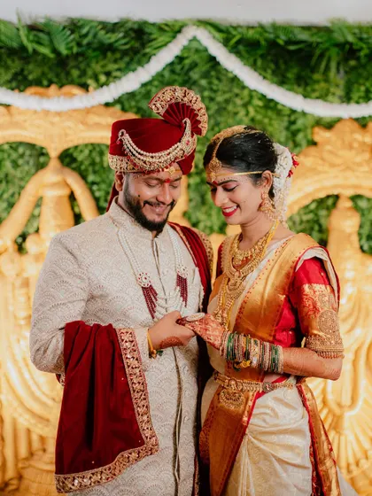 A candid moment of the couple interacting on their wedding stage.