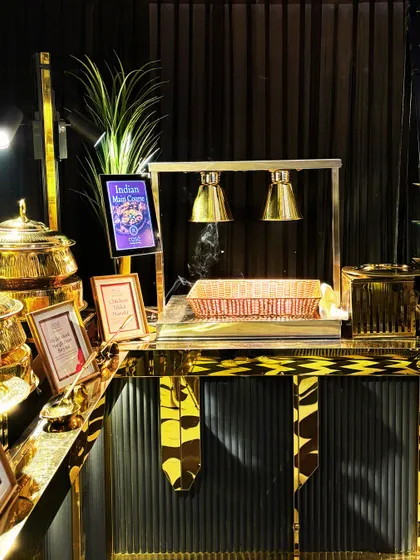 A live station for Indian breads, complete with heat lamps to keep the naan and rotis warm and fresh. This setup ensures guests enjoy soft, hot bread with their main courses.