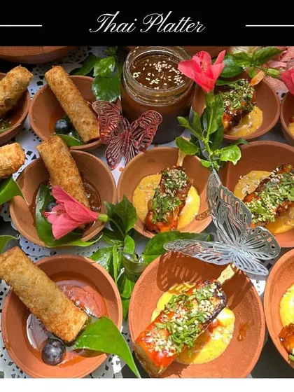 My Thai Platter offers a taste of Thailand's vibrant street food. It includes crispy Thai Cigar Rolls and savoury Paneer Satay skewers with a tangy dipping sauce.
