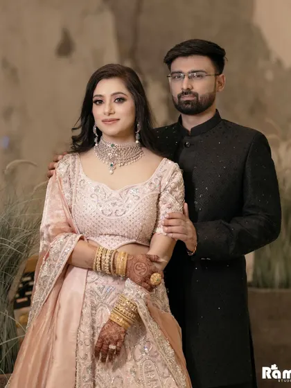 A formal and elegant portrait of the engaged couple. The bride's hand on the groom's shoulder and their direct gaze at the camera create a classic and timeless feel.