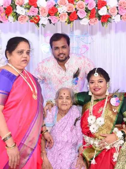 The whole family comes together for a group photo, celebrating with the mom-to-be and her grandmother.