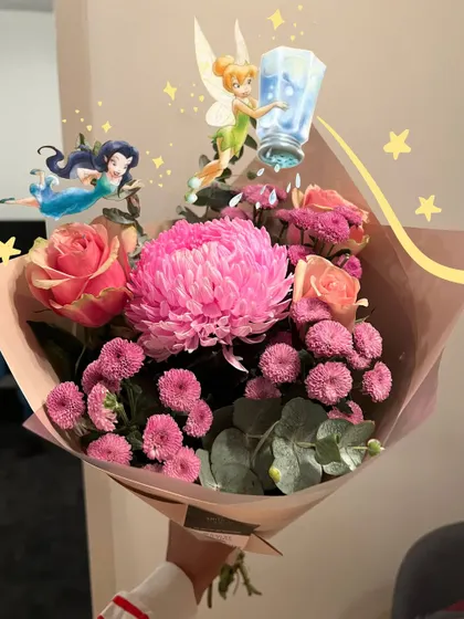 A beautiful bouquet of pink flowers, with some fairy doodles to add a touch of magic.