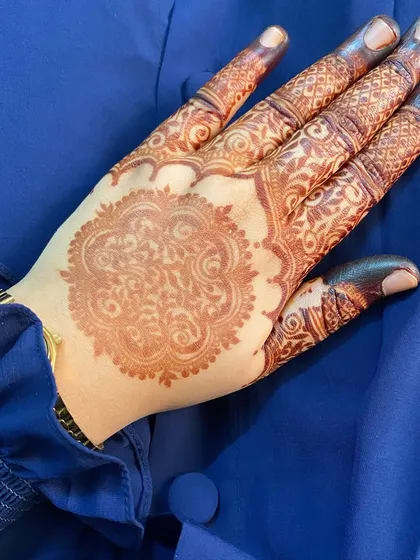 A gorgeous stain from a mandala design, set against a vibrant blue fabric. The color contrast is just beautiful.