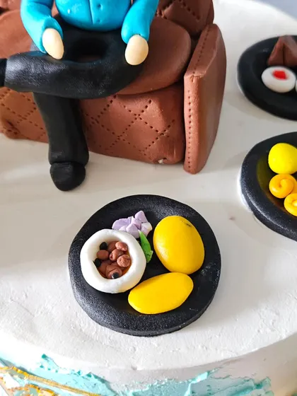 A close-up of the miniature edible food plates from the personalized dad cake. Here you can see the detail on the tiny bowl of rajma, mango slices, and other favorite snacks, all sculpted by hand.