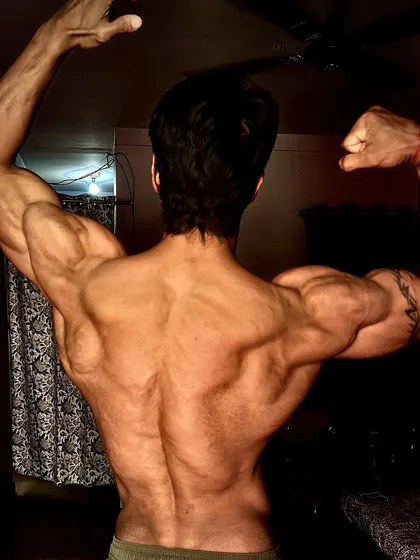 A back double biceps pose, showing the result of preparing for and achieving real change.