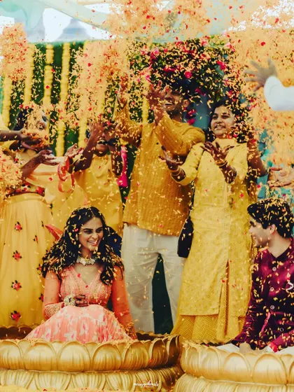 Another shot of the joyous petal shower, a highlight of any Haldi ceremony.