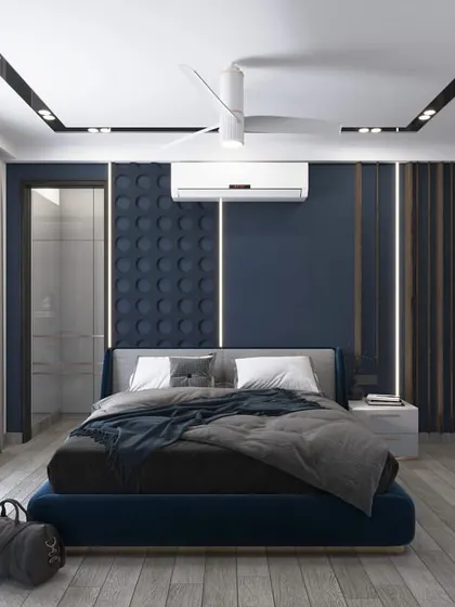 A render of the same son's room, focusing on the bed area. The headboard wall features 3D panels in a deep blue, creating a textured and masculine focal point.