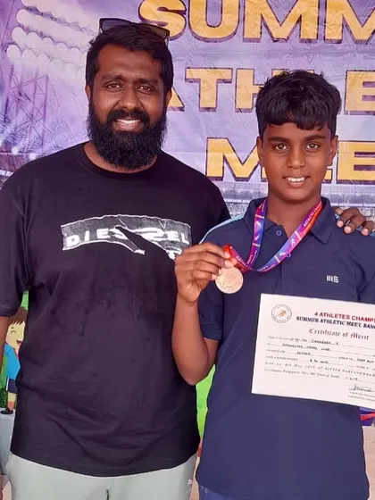 Our coach with a young athlete who won a bronze medal in the 100m sprint at the Summer Athletic Meet.