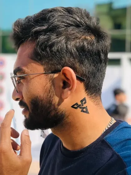 A different geometric symbol painted behind the ear. This placement is subtle yet stylish.
