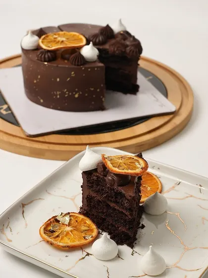 A beautifully plated slice of my Chocolate Orange Cake, showing the dark, moist sponge and the vibrant candied orange garnish.