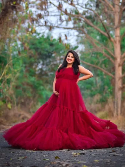 A joyful solo portrait in our red tiered ball gown. The full skirt creates a beautiful silhouette, making it a fantastic option for an outdoor maternity session.