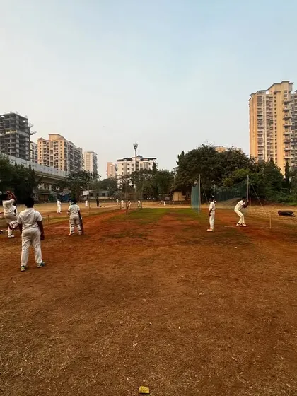 A wide shot of our outdoor ground during an evening session. This facility allows us to conduct full-scale practice matches and extensive fielding drills.