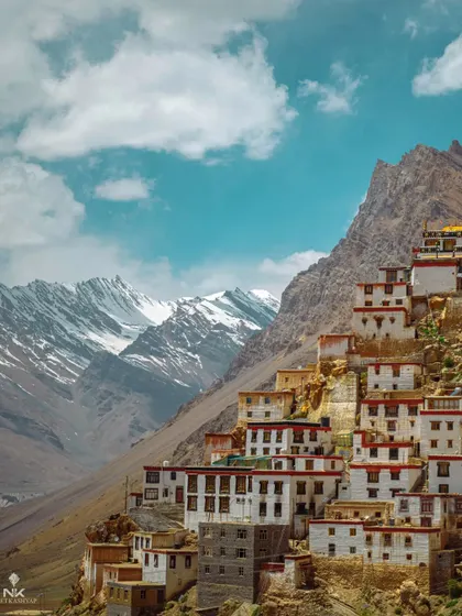 A different perspective of the famous Key Monastery in Spiti. The vertical composition emphasizes the height and precariousness of the ancient structure against the Himalayan backdrop.