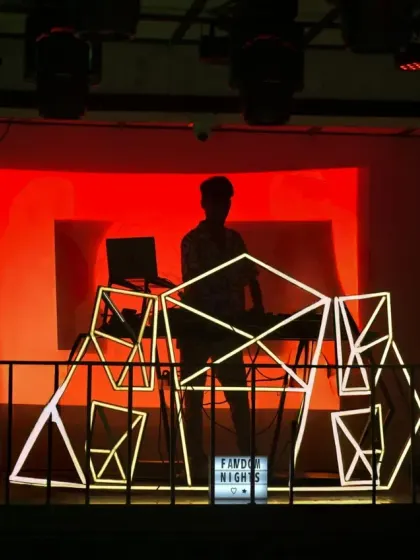 A silhouette shot from a Hip Hop Tamizha fan party. My custom geometric console and the massive VDJ screen are central to the visual identity of my sets.