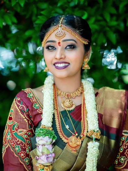 A stunning portrait of a South Indian bride in her muhurtham attire, adorned with traditional jewelry.