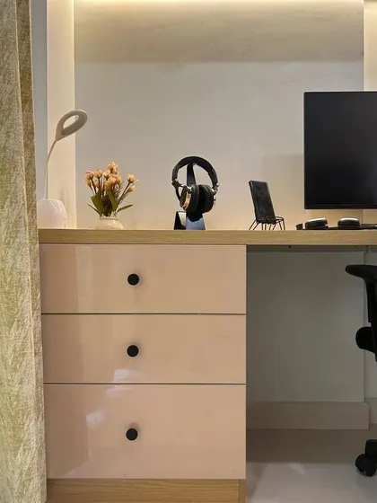 A close-up of the study desk, showing the clean lines and simple, elegant hardware.