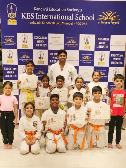A group of proud students at KES International School after their belt and certificate distribution. We offer karate programs in schools to make martial arts accessible to more children.