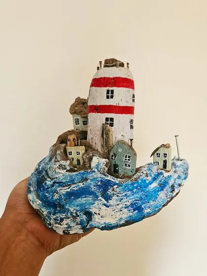 This whimsical miniature world, "The Crowded Shore," is built on a piece of found driftwood. We love giving new life to natural materials, creating tiny, detailed sculptures that spark imagination and joy.