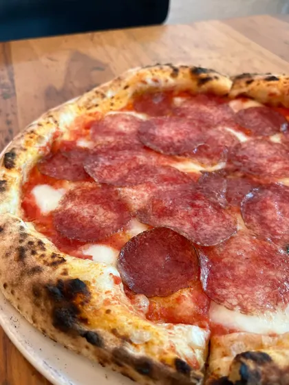 A close-up of the Hungarian Salami pizza, showing the rich colour and texture of the salami.
