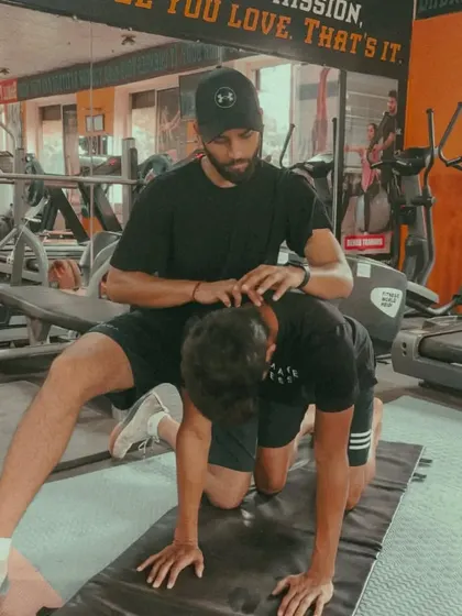 A hands-on approach to wellness. I am applying gentle pressure to an athlete's neck during a specific stretch, guiding them into a position that releases tension and improves range of motion.