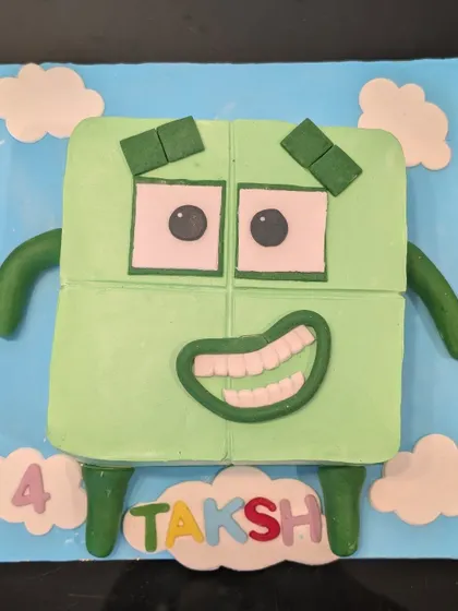 A fun Numberblocks character cake for a 4th birthday. I used fondant to create the block character, complete with his happy expression, and personalized it with the birthday boy's name.