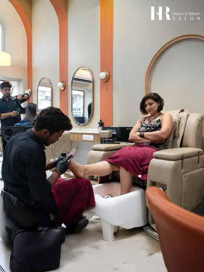 A moment of pure relaxation. A client enjoys a luxurious pedicure in our comfortable, state-of-the-art pedicure chairs while our technician provides expert care.