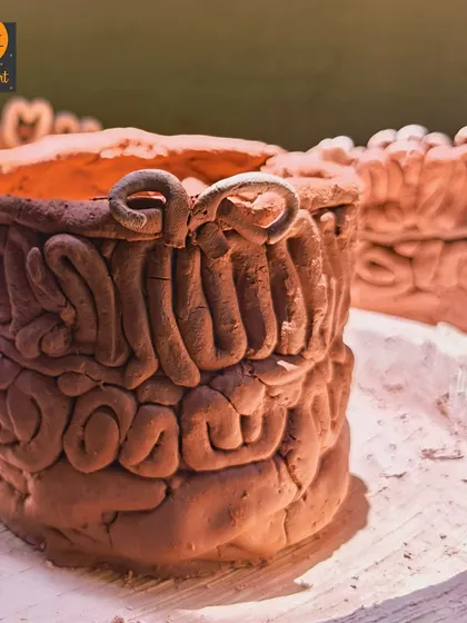 A close-up of a finished coiled pot, showcasing the beautiful, rustic texture created by this ancient technique.