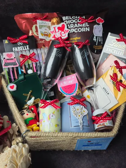 A close-up shot of the items inside our couple's hamper, showing the mix of personalized gifts, snacks, and fun keepsakes.
