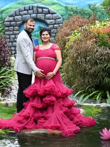 This couple chose a vibrant pink gown for their outdoor shoot. The garden location with its stone archway provides a lovely fairytale setting.