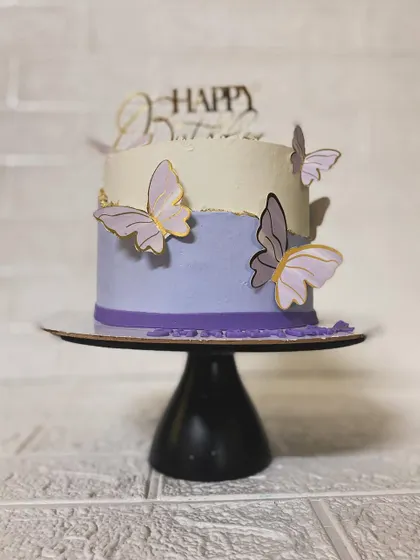 The elegant profile of our butterfly cake on a stand.