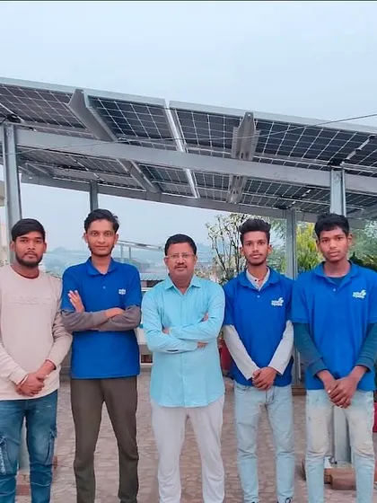 A customer stands with our installation team in his beautiful rooftop garden, now powered by clean solar energy.