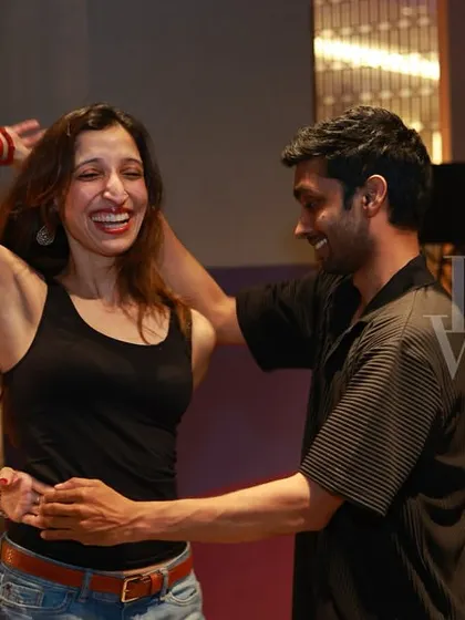 A moment of laughter and fun between two dancers. The genuine smiles show the relaxed and happy atmosphere of our socials.